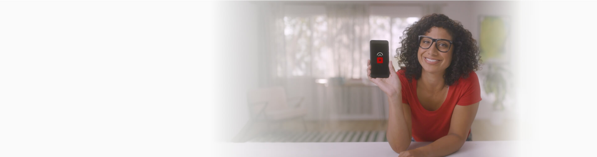 Woman in red shirt and glasses holding a cell phone Woman in red shirt and glasses holding a cell phone